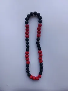 Close-up detail of 12mm red and black Shambhala pavé crystal beads on this elastic necklace