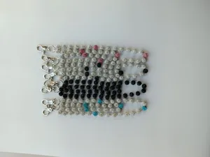 Detail shot of sparkling rhinestone shamballa bead waist and pants chains in multiple colors.