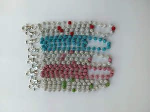 Detailed view of sparkly rhinestone shamballa bead pant chains with lobster clasps.