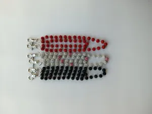 Detailed view of sparkly rhinestone shamballa bead pants chains with metal clasps in colors.