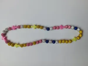 Detailed view of colorful rhinestone disco ball beads and cross spacers on elastic necklace