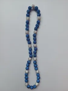 Close-up of blue and white Shamballa necklace featuring sparkling rhinestone clay beads