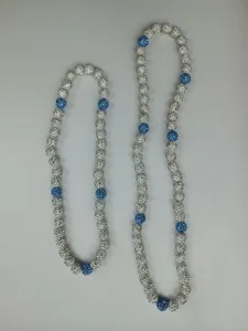 Detail of Shamballa necklaces featuring blue and white rhinestone-paved clay beads