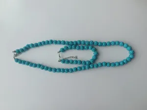 Detailed view of turquoise Shamballa necklace and bracelet set with 10mm rhinestone beads.