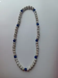 Detailed view of a Shamballa necklace featuring sparkling blue and white pavé beads.
