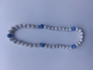 Detailed view of Shamballa necklace with blue and white pave rhinestone disco ball beads
