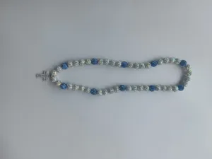 Shamballa necklace detail with blue and white rhinestone disco ball beads and sparkling cross.