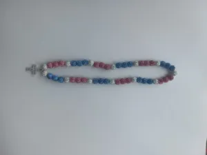 Sparkling Shamballa necklace with pink and blue beads and a crystal cross pendant.