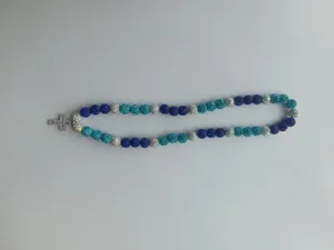 Detail of sparkling Shamballa necklace beads with shimmering silver cross pendant