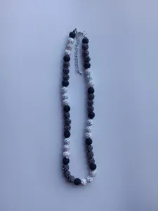 Detailed view of the black and white rhinestone Shamballa bead necklace with metal clasp.