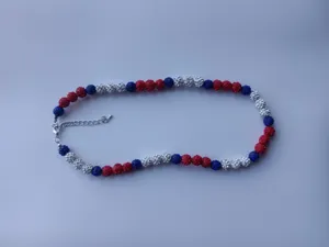 Detailed close-up shot of the red, white and blue shamballa beaded necklace with lobster clasp.
