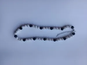 Detail shot of black and white rhinestone pave shamballa balls necklace with chain.