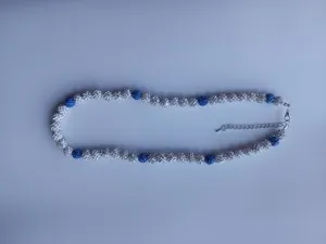 Close-up detail of Shamballa rhinestone beaded necklace with blue and white crystals.