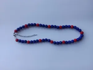 Detail view of the red and blue rhinestone shamballa beaded necklace with lobster clasp.