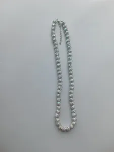 Detailed close-up shot of white rhinestone shamballa disco ball bead necklace with extension chain.