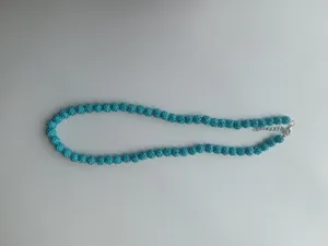 Detailed view of blue rhinestone shamballa ball necklace with lobster clasp and chain.