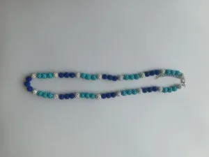 Blue crystal pave ball necklace detail view, featuring sparkling rhinestones and lobster clasp.