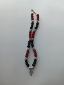 Detailed view of the red black silver shamballa rhinestone beaded necklace with a cross pendant.
