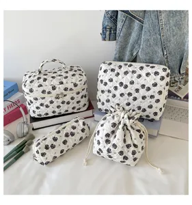 Set of four quilted floral storage bags in various sizes displayed in a lifestyle setting