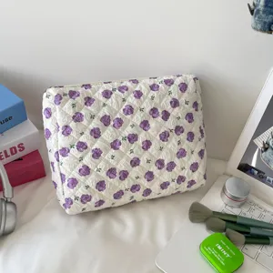 Macro view of the large capacity quilted floral cosmetic bag with purple rose pattern