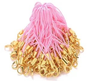 Detail view of pink mobile phone lanyards featuring shiny gold lobster clasps for DIY crafts.