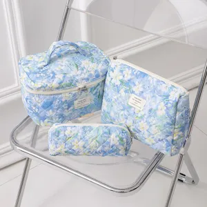 Blue floral quilted cotton cosmetic bag set including large pouch and small case