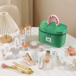 Green large capacity makeup bag with numbered pink handle shown in a vanity scene