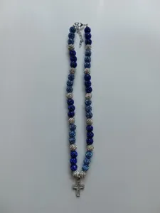 Detailed view of blue and silver Shamballa bead necklace with rhinestone cross pendant