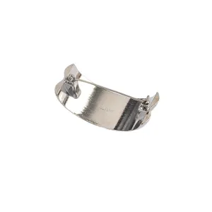Back view of silver C-shaped textured metal brooch with safety pin clasp