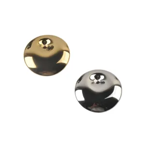 Detailed view of polished gold and silver circular stainless steel brooches