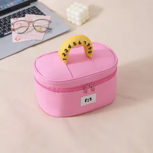 Close-up of cute pink cosmetic bag with contrast yellow number handle and dual zippers