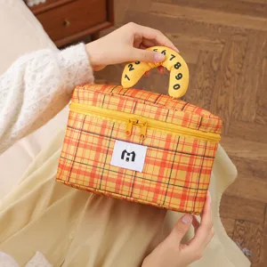 Detailed view of a yellow plaid large capacity makeup bag with a unique numbered handle