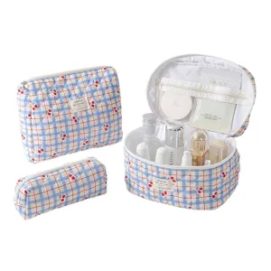 Three-piece quilted cotton cosmetic bag set with blue grid and cherry pattern