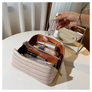 Detailed view of cream crocodile makeup bag showing large capacity multi-compartments