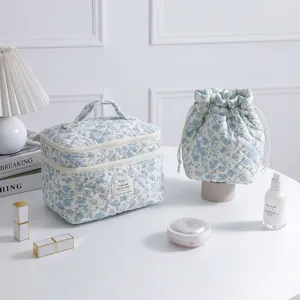 Detailed view of the light blue floral quilted makeup bag and matching drawstring pouch.