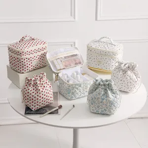 Floral quilted makeup bag set showing large capacity and matching drawstring pouches.