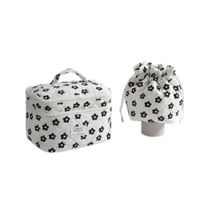 Quilted floral cosmetic bag set with white and black daisy pattern and drawstring pouch