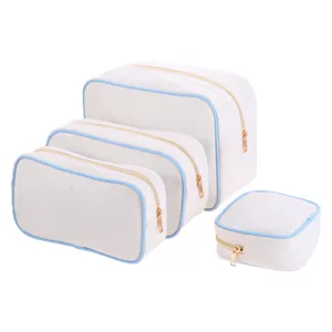 Set of 4 canvas storage bags with blue piping and gold zippers on white background