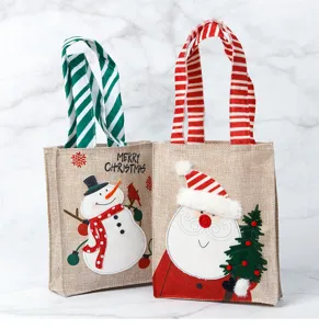 Detailed macro view of linen Christmas gift bags featuring Santa and Snowman illustrations