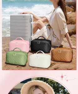 Quilted large capacity travel cosmetic bags in various colors shown on beach rocks