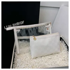 Detail view of 2-piece PVC cosmetic bag set in a gift box with white shredded paper