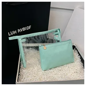 Detailed view of a mint green PVC travel cosmetic bag set in a gift packaging box