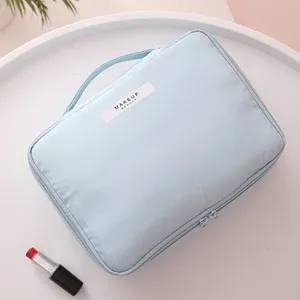 Large capacity light blue portable makeup bag with handle and minimalist zipper closure