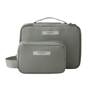 Set of two minimalist grey makeup bags with large capacity for travel storage.
