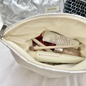 Interior view of quilted silver PU heart makeup bag showing storage capacity.