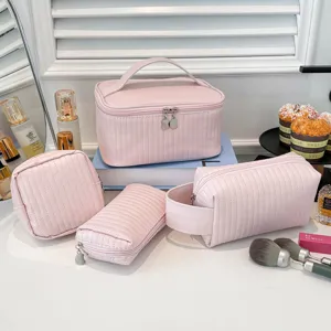 Detailed view of 4-piece pink quilted PU leather makeup bag set in lifestyle setting