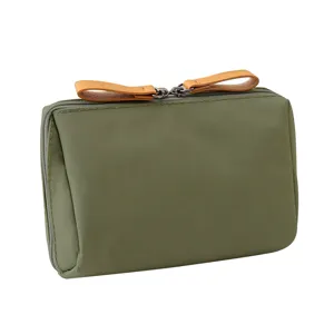 Portable olive green mini cosmetic pouch featuring double zipper and leather pull tabs