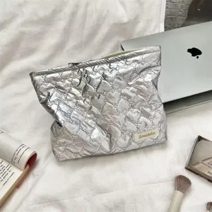 Silver quilted heart PU leather cosmetic bag shown in a lifestyle makeup scene