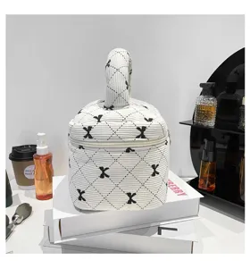 Detailed view of the white corduroy bucket bag with butterfly bow print patterns