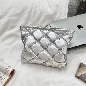Detailed close-up showing the metallic diamond quilted texture of the silver PU bag